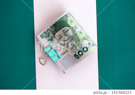 Nigerian naira currency money bills lies on flag. The concept of business and investment Nigerian naira currency money bills lies on flag. The concept of business and investment 142368225