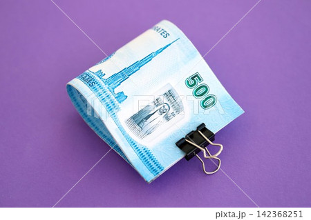 United Arab Emirates dirham money bills in big amount on purple. Finance and banking concept United Arab Emirates dirham money bills in big amount on purple. Finance and banking concept 142368251