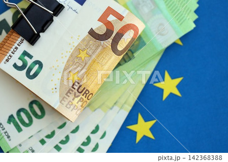 European euro currency money notes bunch on Europe union blue flag close up 142368388
