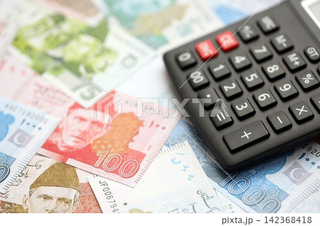 Pakistan rupees banknotes and calculator. The current Pakistan money bills with calculator 142368418