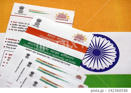 Indian Aadhaar card from Unique Identification Authority of India on Indian flag Indian Aadhaar card from Unique Identification Authority of India on Indian flag 142368586
