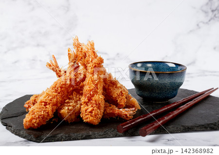 shrimp in tempura, deep fried, on black slate, with sauce, light marble table, no people, shrimp in tempura, deep fried, on black slate, with sauce, light marble table, no people, 142368982