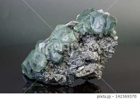 macro mineral stone green fluorite on a black background macro mineral stone green fluorite on a black background 142369370