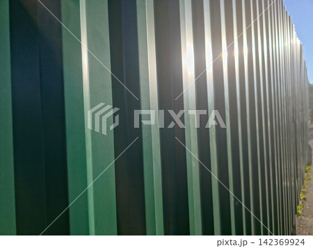 Shining Green Iron Fence Reflecting Sunlight in a Serene Garden Setting Shining Green Iron Fence Reflecting Sunlight in a Serene Garden Setting 142369924