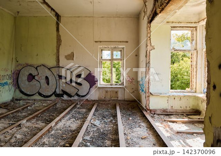 Neglected space with windows revealing natural recovery beyond walls Neglected space with windows revealing natural recovery beyond walls 142370096