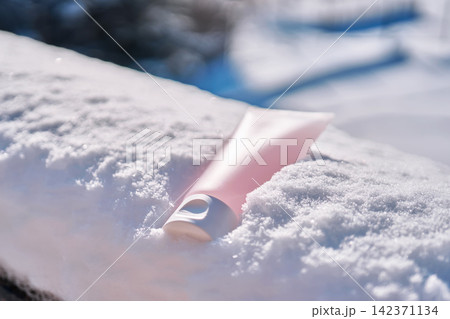 Hand cream tube in snow protecting winter skin Hand cream tube in snow protecting winter skin 142371134