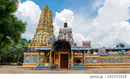 Colorful Hindu Temple Gopuram Under Dramatic Cloudy Sky Colorful Hindu Temple Gopuram Under Dramatic Cloudy Sky 142372028