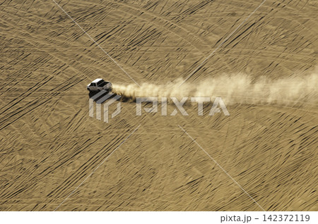 Aerial Desert Off-Road Truck Driving Through Sand Dunes Aerial Desert Off-Road Truck Driving Through Sand Dunes 142372119
