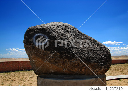 Large Meteorite Rock in Desert Landscape Under Blue Sky Large Meteorite Rock in Desert Landscape Under Blue Sky 142372194