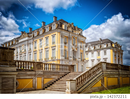 Baroque Palace Exterior with Grand Staircase and Dramatic Sky 142372211