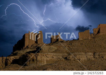 Lightning Storm Over Ancient Desert Ruins at Night Lightning Storm Over Ancient Desert Ruins at Night 142372263