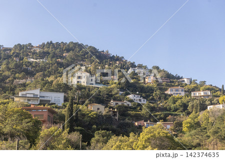 Upscale Mediterranean villas cling to steep volcanic rocks of the Esterel Massif between Cannes and Nice. Upscale Mediterranean villas cling to steep volcanic rocks of the Esterel Massif between Cannes and Nice. 142374635