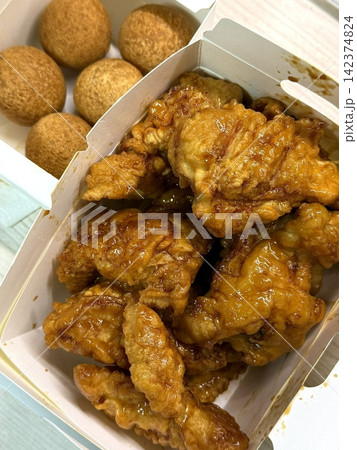 Crispy Korean fried chicken, perfectly glazed with a sweet and spicy sauce. Ideal for food photography and menus, showcasing the irresistible crunch and flavor of this beloved dish. Crispy Korean fried chicken, perfectly glazed with a sweet and spicy sauce. Ideal for food photography and menus, showcasing the irresistible crunch and flavor of this beloved dish. 142374824