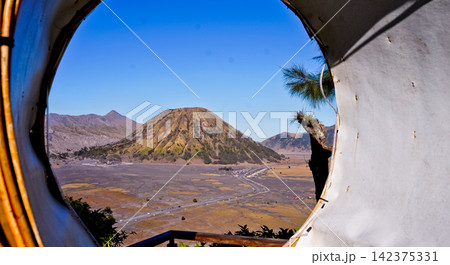 View of Mount Bromo framed by a rattan circle. 142375331