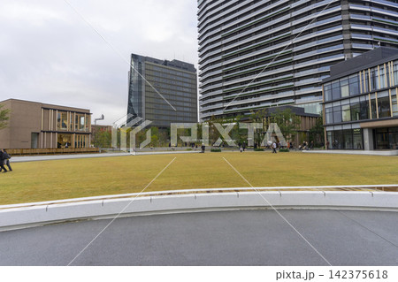 Tokyo, Japan - Nov 21,2024 : People resting on the lawn of the japan sport olympic square, Hope Square in Tokyo, Japan on Nov 21,2024. Tokyo, Japan - Nov 21,2024 : People resting on the lawn of the japan sport olympic square, Hope Square in Tokyo, Japan on Nov 21,2024. 142375618