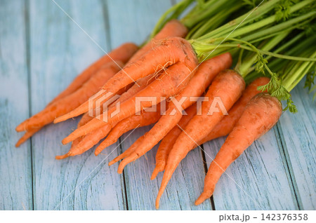 carrot on table background, Fresh and sweet carrots for cooking food fruits and vegetables for health concept, baby carrots bunch and leaf 142376358