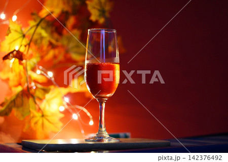 Champagne glass on table against blurred lights background - perspective of crystal clear wine glass for night party on the counter top bar restaurant 142376492