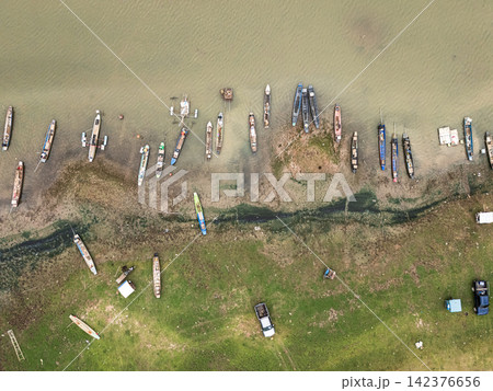 Aerial View of Reservoir Shoreline with Small Boats and Exposed Floodplain 142376656