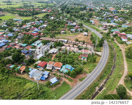 Aerial View of Rural Residential Area with Curving Road and Green Landscape Aerial View of Rural Residential Area with Curving Road and Green Landscape 142376657