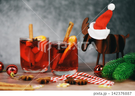 Christmas mulled wine delicious holiday like parties with orange cinnamon star anise spices for traditional christmas drinks winter holidays red mulled wine glasses reindeer decorated 142376887
