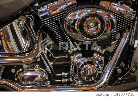 Chrome Motorcycle Engine Close-Up with Polished Mechanical Detail Chrome Motorcycle Engine Close-Up with Polished Mechanical Detail 142377716