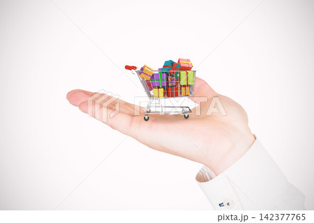 Shopping Cart With Gift Boxes on Open Hand Shopping Cart With Gift Boxes on Open Hand 142377765