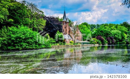 Castle by Tranquil Lake in Lush Green European Park Castle by Tranquil Lake in Lush Green European Park 142378100