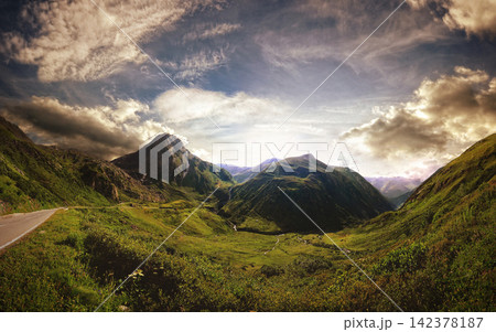 Mountain Valley Panorama with Dramatic Sky and Scenic Road Mountain Valley Panorama with Dramatic Sky and Scenic Road 142378187