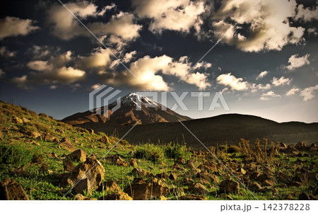 Snow-Capped Volcano Landscape with Dramatic Clouds 142378228