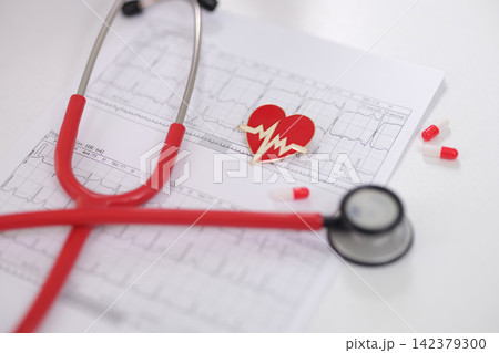 Electrocardiogram of heart and stethoscope with medications for analysis of cardiovascular disease closeup Electrocardiogram of heart and stethoscope with medications for analysis of cardiovascular disease closeup 142379300