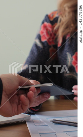 Vertical video. British embassy woman officer giving passport to man immigrant, student visa approval, work visa, citizenship. Visa Application online form immigration concept. Visa approval. 142379866