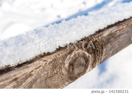 Frost snowflakes on wood, bridge with sun and snow Frost snowflakes on wood, bridge with sun and snow 142380231