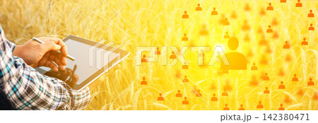 Farmer using a digital tablet in a ripe wheat field with glowing human profile icons overlay. Agricultural technology, smart farming, and crop management concept Farmer using a digital tablet in a ripe wheat field with glowing human profile icons overlay. Agricultural technology, smart farming, and crop management concept 142380471