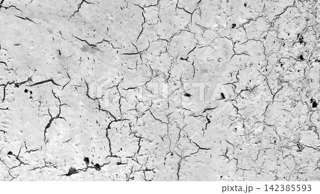 Black and white cracked concrete wall texture with a spiderweb pattern. 142385593