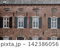 Ancient castle window with wooden shutters, European historic architecture. Medieval castle interior window with traditional shutters and rustic details 142386056