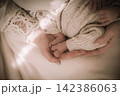 Tender Close-Up of Mother Holding Her Babys Tiny Feet, Symbolizing Maternal Love, Care, Family Bond and the Precious Moments of Early Childhood 142386063