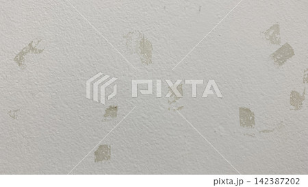 Full frame background texture of white painted wall with adhesive tape residue marks Full frame background texture of white painted wall with adhesive tape residue marks 142387202