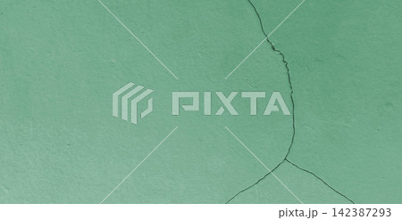 Cracked surface texture on a green painted wall. Cracked surface texture on a green painted wall. 142387293