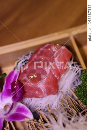 Fresh Tuna Sashimi with Orchid Garnish Fresh Tuna Sashimi with Orchid Garnish 142387535