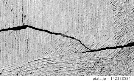 Horizontal cracks with branching cracks on a textured plaster wall. Horizontal cracks with branching cracks on a textured plaster wall. 142388584