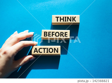 Think before action symbol. Concept words think before action on wooden blocks arranged as steps. Businessman hand arranging wooden blocks. Decision making and planning concept. Blue background. Copy Think before action symbol. Concept words think before action on wooden blocks arranged as steps. Businessman hand arranging wooden blocks. Decision making and planning concept. Blue background. Copy 142388821