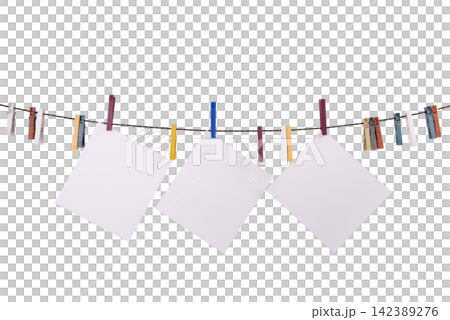 Three blank white squares of paper are hanging on a clothesline with colorful clothespins Three blank white squares of paper are hanging on a clothesline with colorful clothespins 142389276