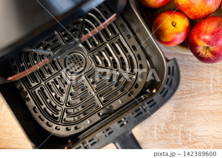 Top view of a clean empty metal grid inside an open air fryer basket Top view of a clean empty metal grid inside an open air fryer basket 142389600