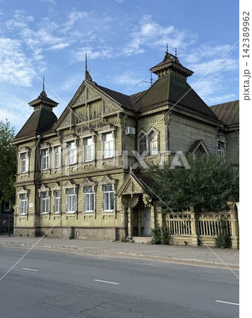 Wooden Victorian house with ornate details against clear blue sky, suitable for architectural background 142389962