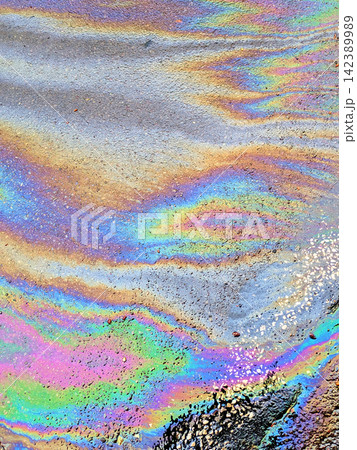 A leaked Car Oil Petrol in The Rain on a Tarmac Road Metallic Rainbow Gasoline A leaked Car Oil Petrol in The Rain on a Tarmac Road Metallic Rainbow Gasoline 142389989