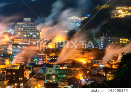 Beppu town with heavy steam of hot spring bath ryokan at night, Oita Beppu town with heavy steam of hot spring bath ryokan at night, Oita 142390379