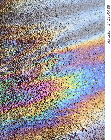 A leaked Car Oil Petrol in The Rain on a Tarmac Road Metallic Rainbow Gasoline A leaked Car Oil Petrol in The Rain on a Tarmac Road Metallic Rainbow Gasoline 142390489