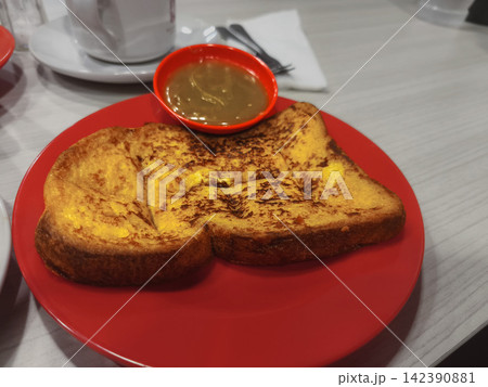 Delicious Indonesian Roti Bakar grilled toast filled with sweet toppings, sliced and served on a plate Delicious Indonesian Roti Bakar grilled toast filled with sweet toppings, sliced and served on a plate 142390881