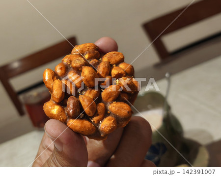 Traditional Indonesian Ampyang sweet snack made of roasted peanuts bound in hardened palm sugar and aromatic ginger 142391007
