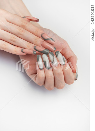 Woman hands with modern gray nail art design Woman hands with modern gray nail art design 142391032
